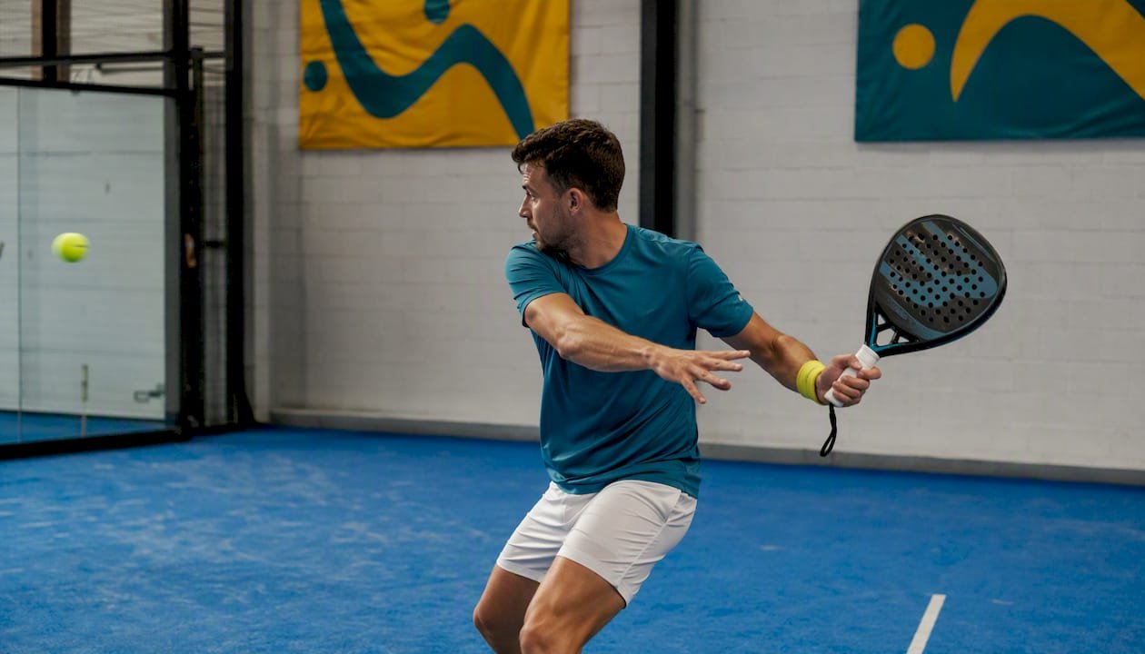 Male player practicing with forgiving padel racket outdoors