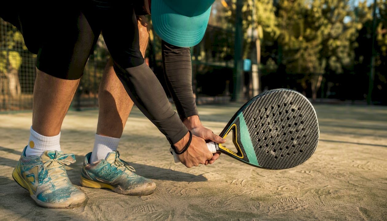 Hands holding lightweight Babolat Air Vert racket overhead