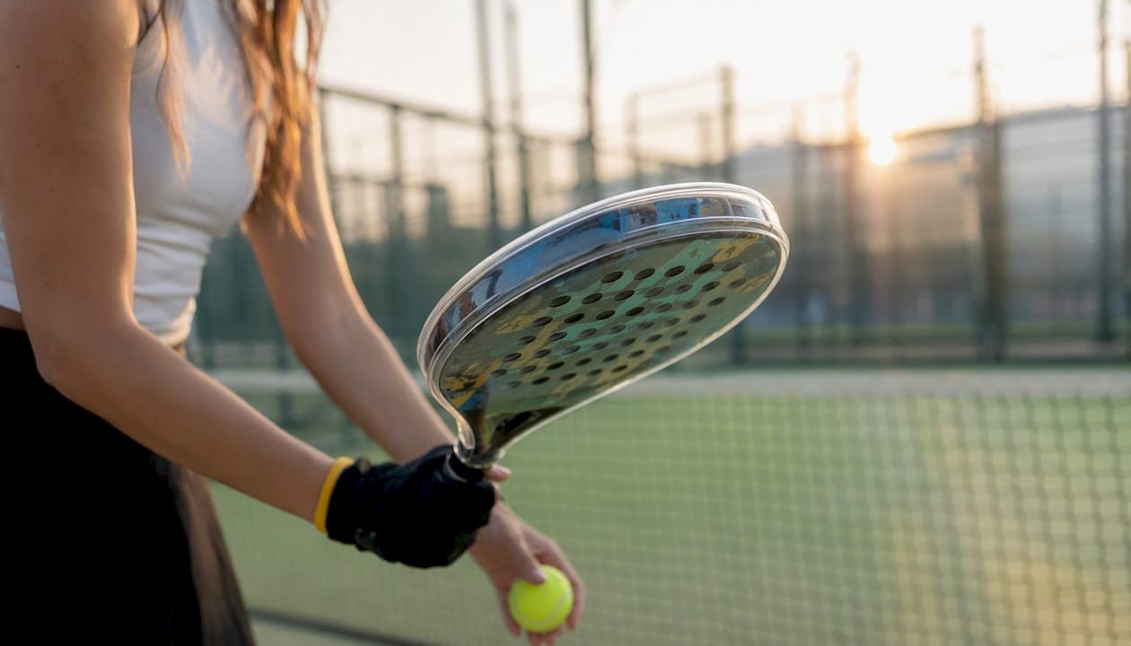 Padel racket with transparent protector on court