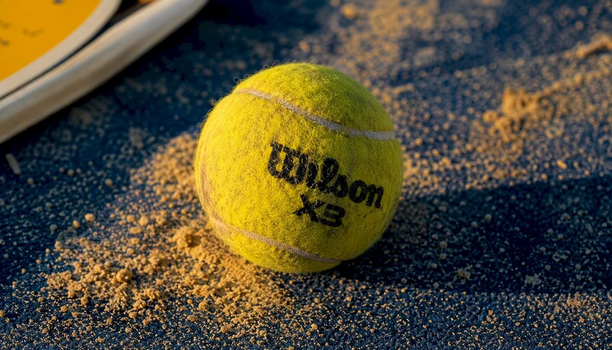 Close-up of worn Wilson X3 padel ball on court