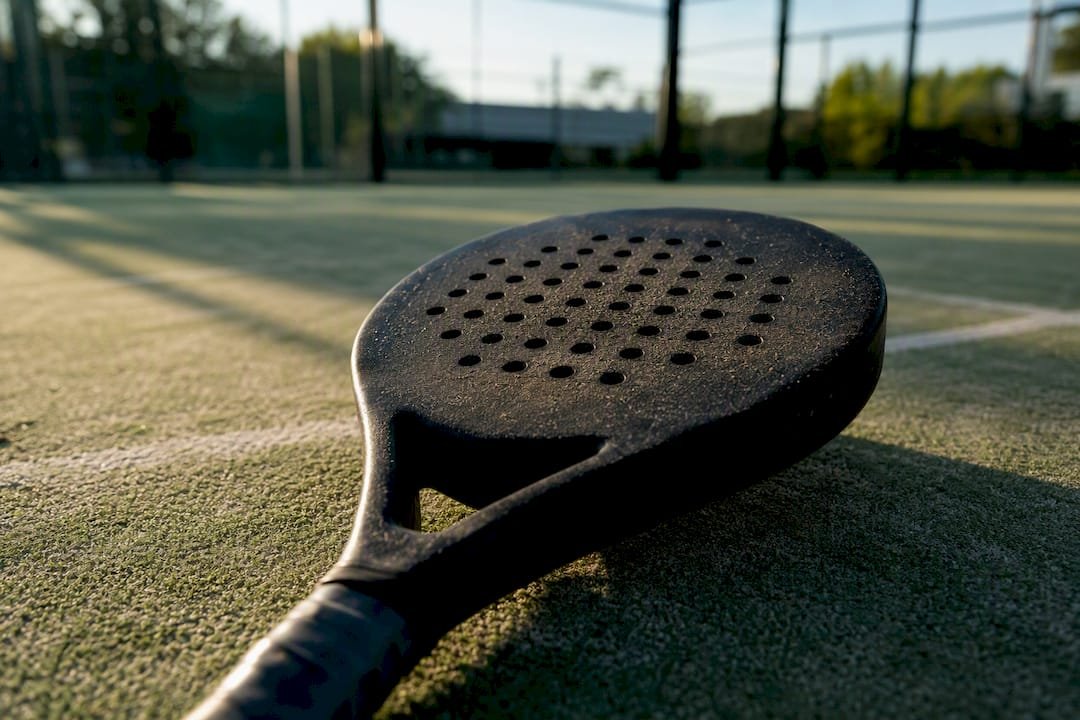 Close-up of diamond padel racket head on court