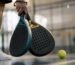 Hands holding two different padel racket shapes