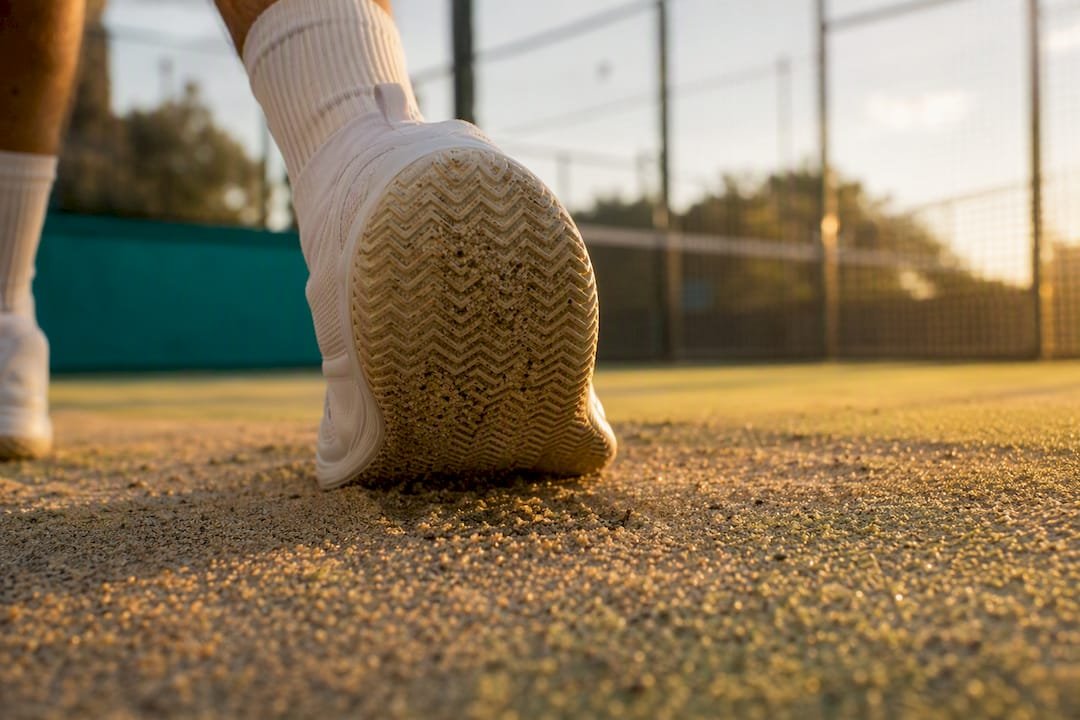 Herringbone sole cutting through sand on turf