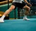 Player making lateral split-step on padel court
